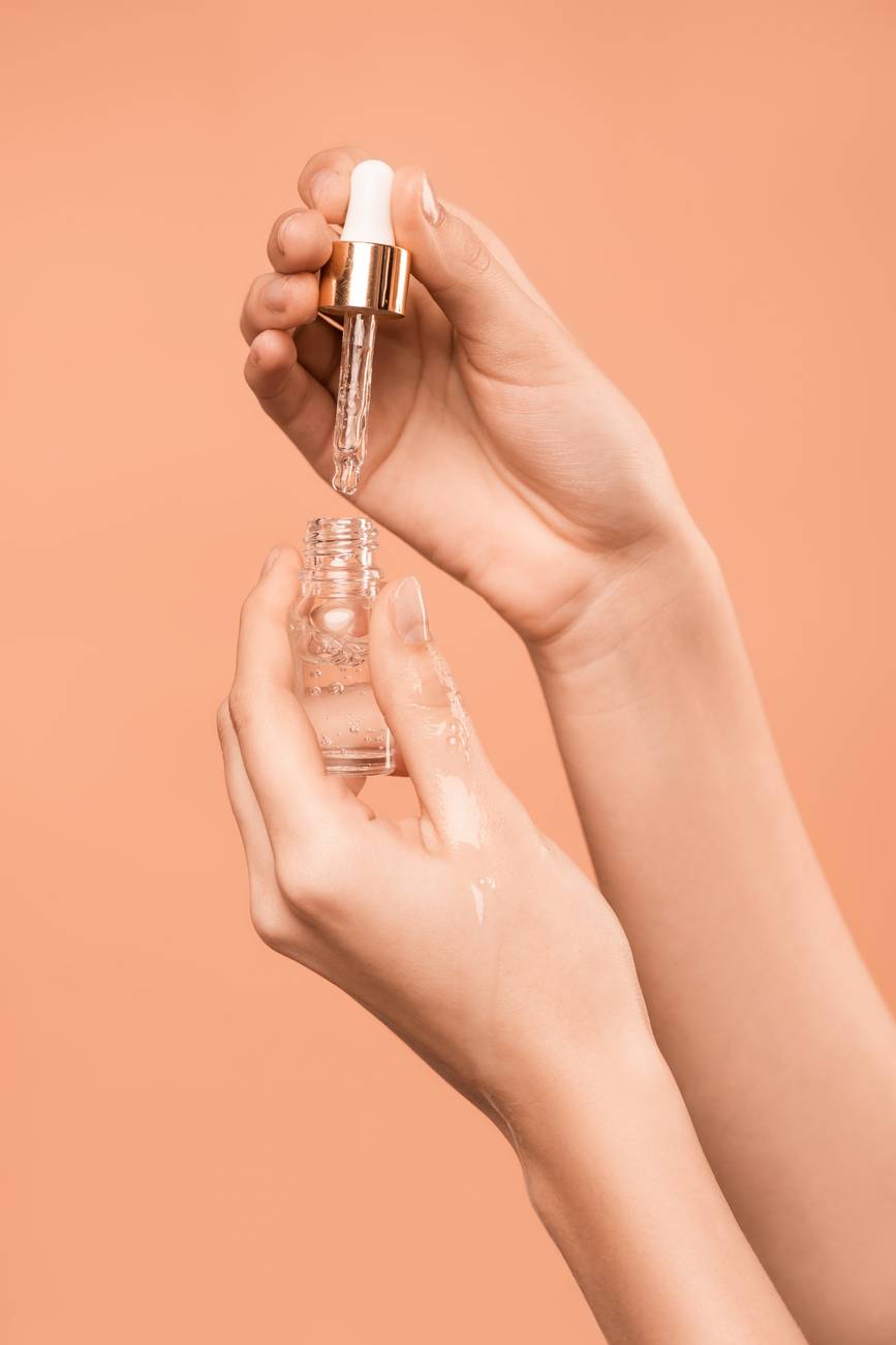 person holding serum bottle